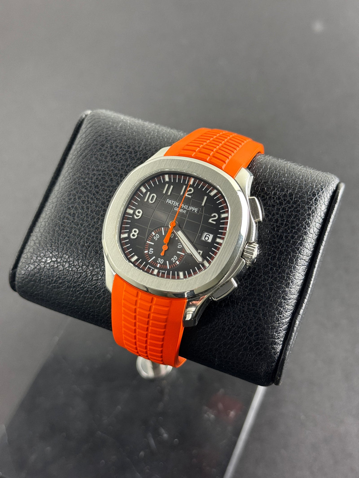 Patek Philippe Aquanaut Chronograph in steel with a black embossed dial and orange tropical strap