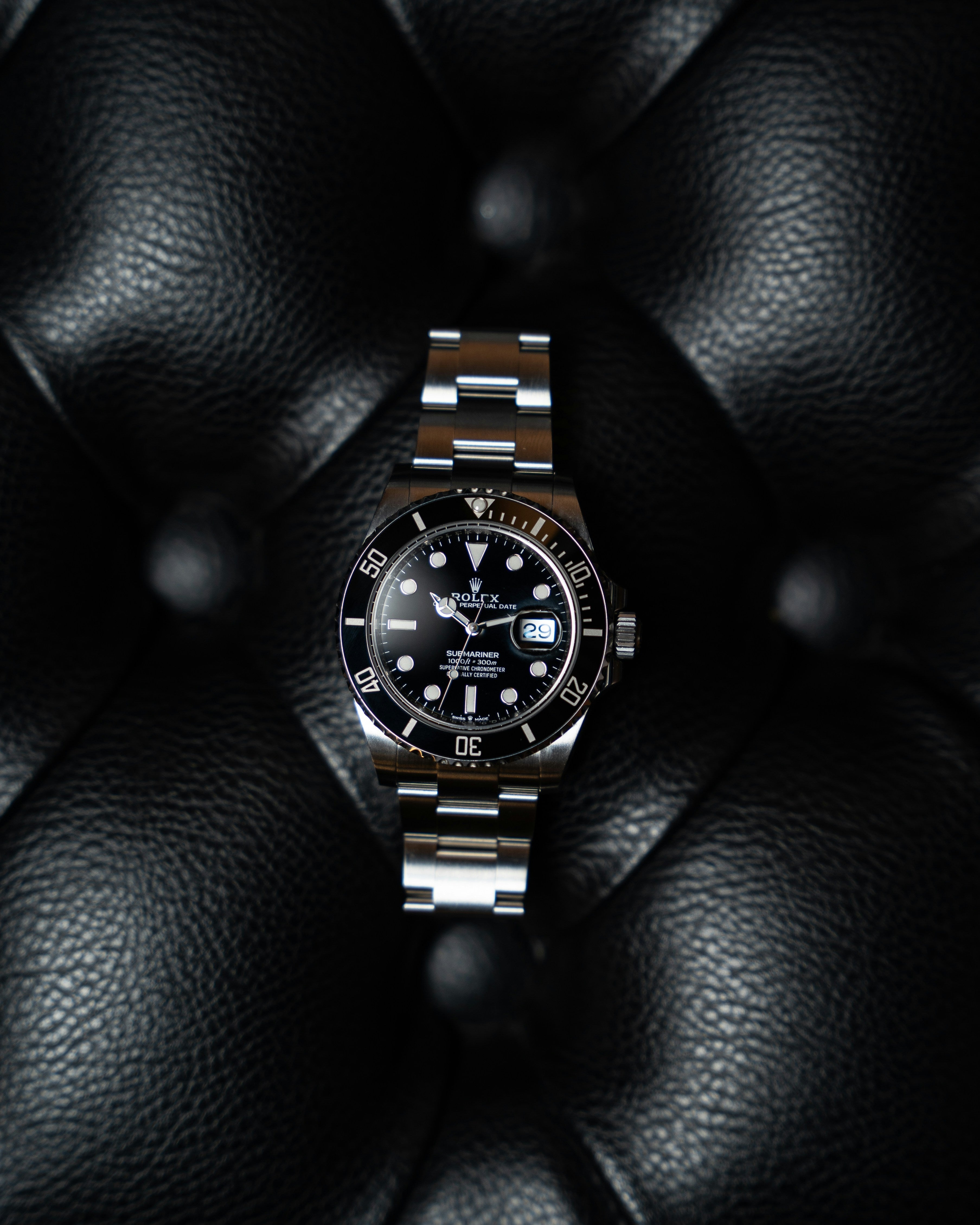 Rolex Submariner black dial ceramic bezel on dark background, iconic diving watch